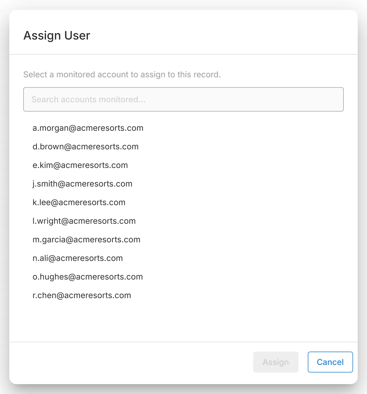 The "Assign User" dialog, with "Search accounts monitored..." above the list of monitored email addresses.
